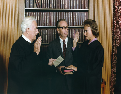 Photograph of Sandra Day O'Connor Being Sworn in a Supreme Court Justice by Chief Justice Warren Burger, Her Husband John O'Connor Looks On