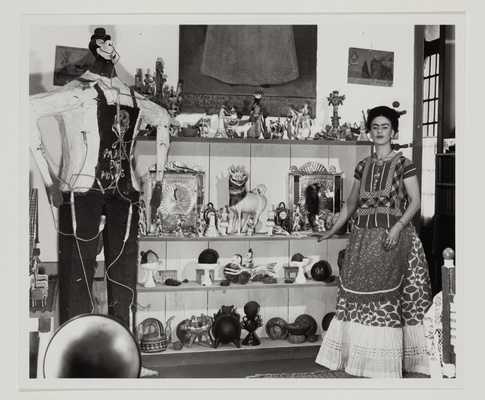 Frida Kahlo in living room with figure of Judas