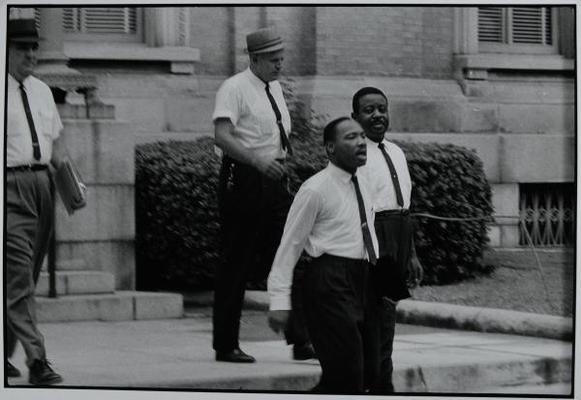 Dr. Martin Luther King Jr. and Reverend Ralph Abernathy are escorted back to jail in Albany, Georgia