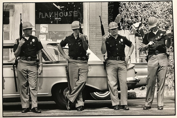 The morning after the bombing of the Sixteenth Street Baptist Church, heavily armed members of the Alabama Highway Patrol make a show of force near the [bombed Sixteenth Street Baptist] church.