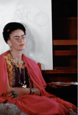 Frida Kahlo sitting by easel, early sketch of The Love Embrace