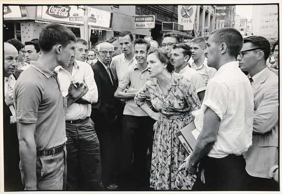 As demonstrators block traffic to protest segregation and unfair hiring practices in downtown Atlanta, a mob begins to abuse them with kicks, blows, and burning cigarettes.